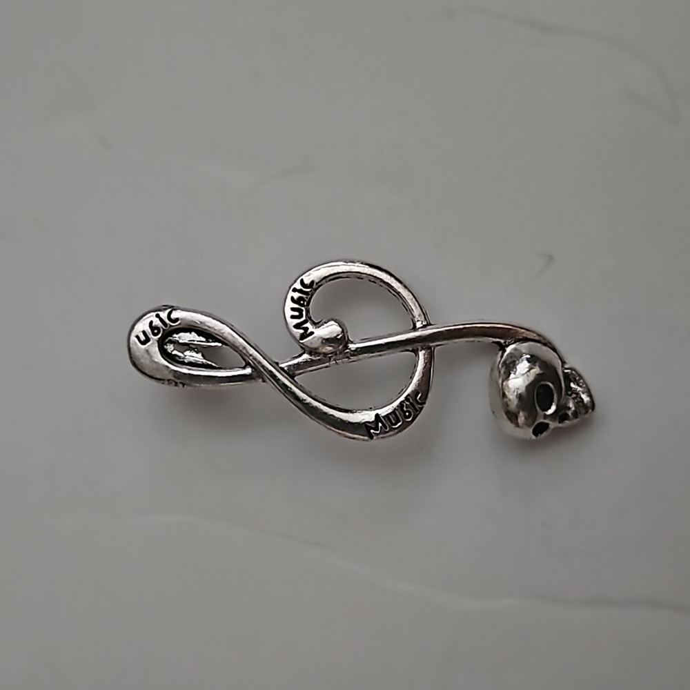 Treble sign pendant with a skull